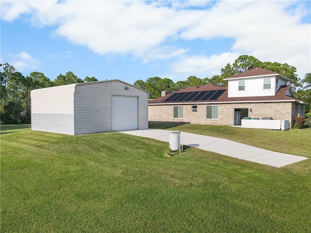 exterior space featuring an outbuilding, a garage, and a lawn