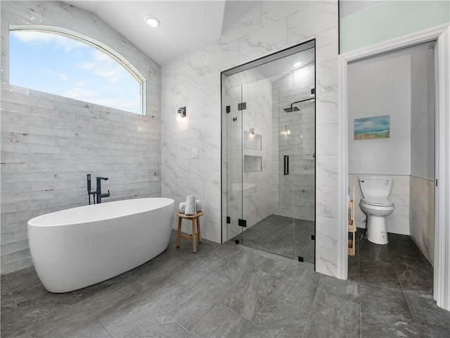 bathroom featuring independent shower and bath, toilet, and tile walls