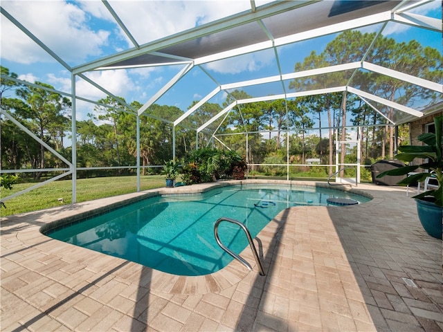 view of swimming pool featuring a patio area and a lanai