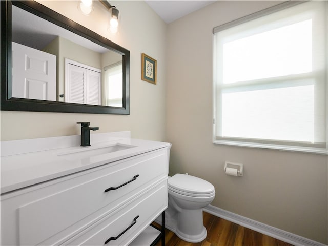 bathroom featuring hardwood / wood-style floors, vanity, and toilet