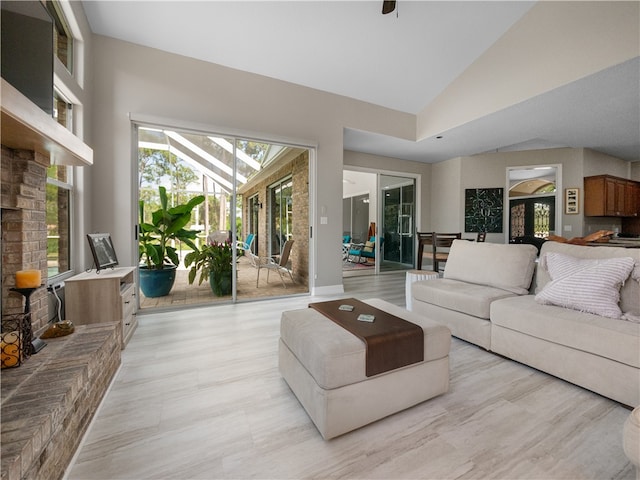 living room with high vaulted ceiling and light hardwood / wood-style flooring