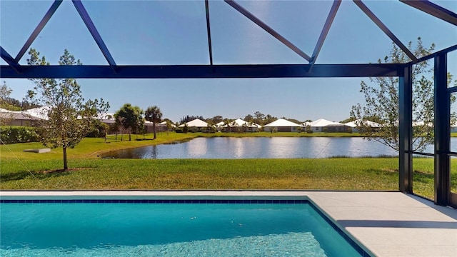 outdoor pool with a lawn, a water view, and a lanai