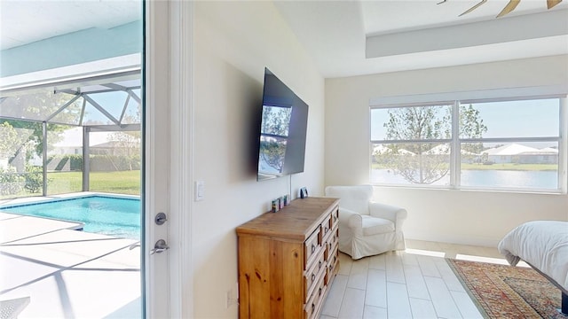 doorway to outside featuring light tile patterned floors, baseboards, a sunroom, and plenty of natural light