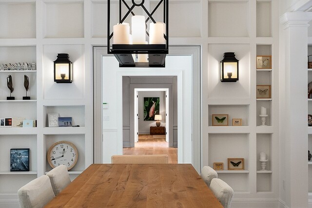 hallway with built in features and ornate columns