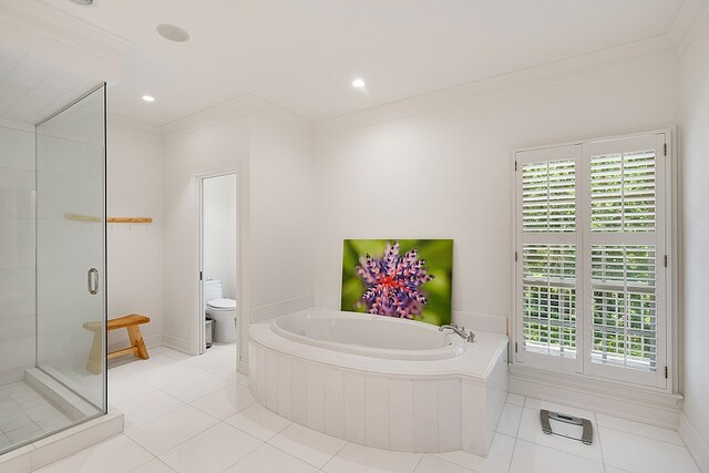 bathroom featuring toilet, independent shower and bath, tile patterned flooring, and plenty of natural light