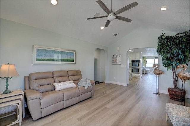 living room with ceiling fan, light hardwood / wood-style flooring, and lofted ceiling