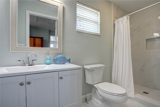 bathroom featuring vanity, toilet, and walk in shower