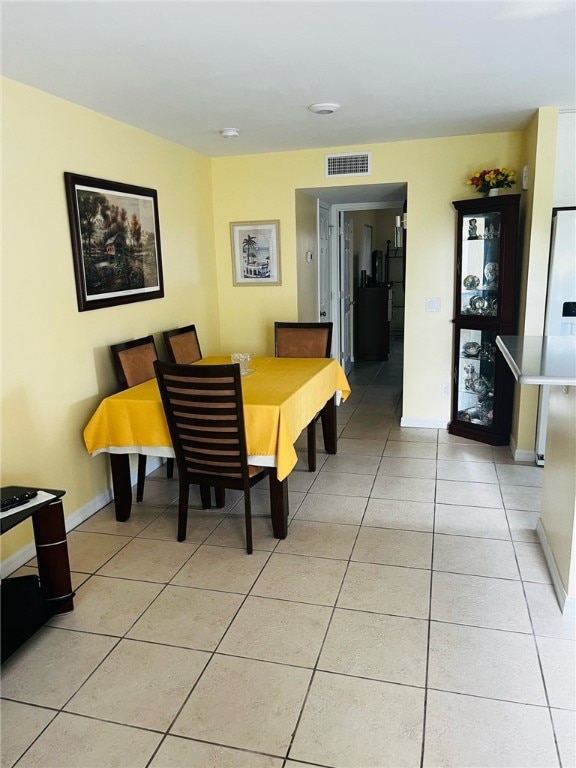 dining space featuring light tile patterned floors