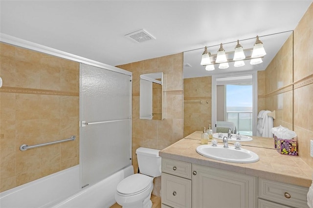 3554 S Ocean Dr Unit 1203, Vero Beach, FL 32963 - full bathroom with tile walls, vanity, and shower / washtub combination