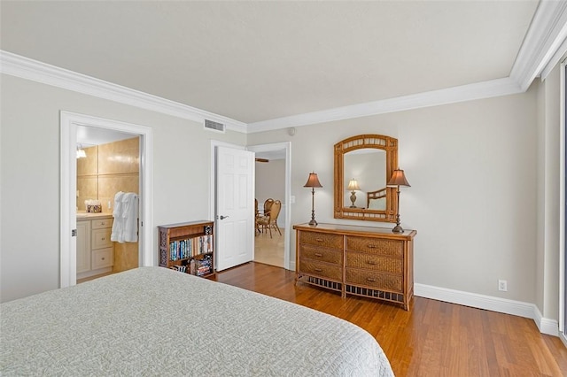 3554 S Ocean Dr Unit 1203, Vero Beach, FL 32963 - bedroom featuring wood finished floors, ornamental molding, and ensuite bath
