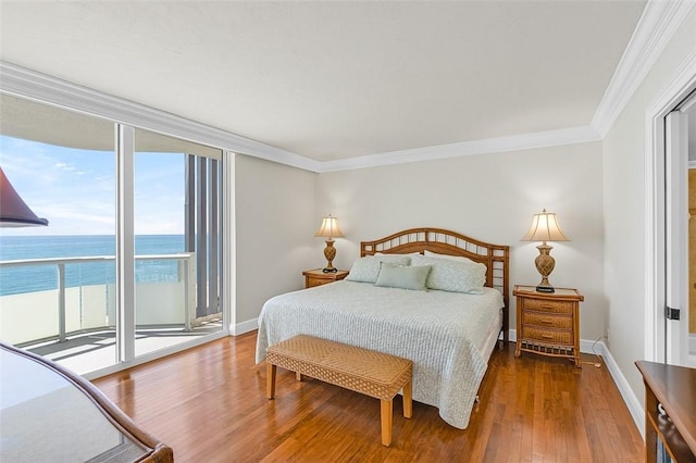 3554 S Ocean Dr Unit 1203, Vero Beach, FL 32963 - bedroom with access to exterior, wood finished floors, ornamental molding, and a water view