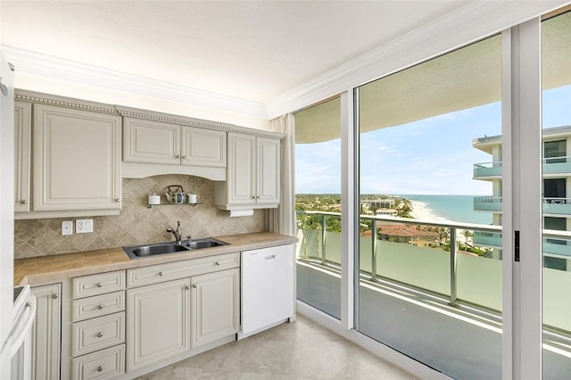 3554 S Ocean Dr Unit 1203, Vero Beach, FL 32963 - kitchen featuring dishwasher, a water view, light countertops, decorative backsplash, and ornamental molding