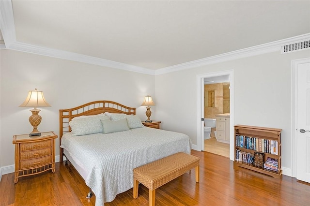 3554 S Ocean Dr Unit 1203, Vero Beach, FL 32963 - bedroom featuring crown molding, wood finished floors, and ensuite bath