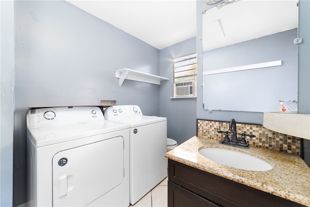 laundry room featuring washing machine and dryer, sink, and light tile patterned floors