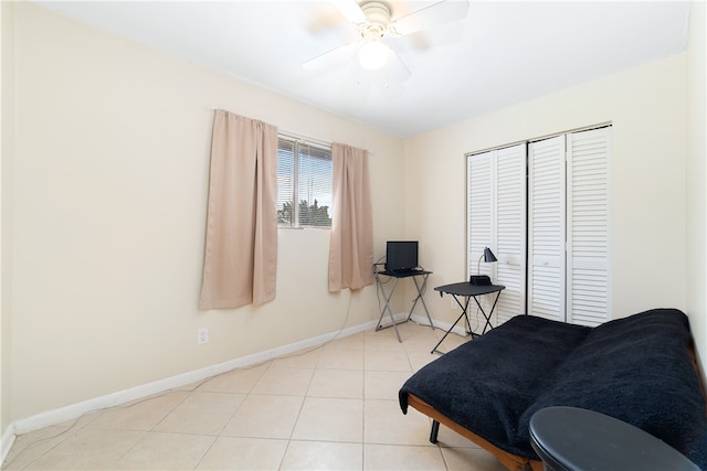 bedroom with a closet, light tile patterned flooring, and ceiling fan