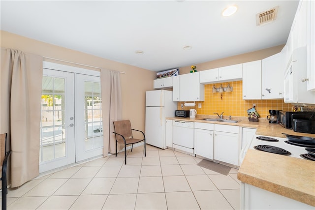 kitchen featuring french doors, white cabinets, decorative backsplash, sink, and white appliances