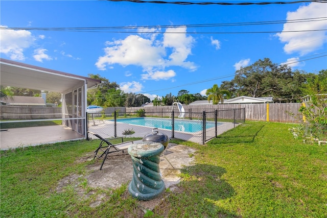 view of pool featuring a patio area, a lawn, and a water slide