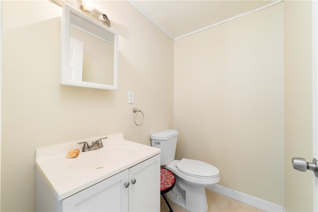 bathroom featuring tile patterned floors, vanity, toilet, and crown molding