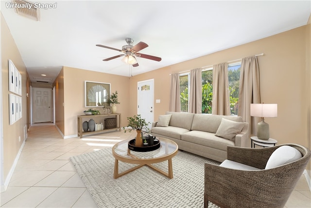 living room featuring ceiling fan and light tile patterned floors