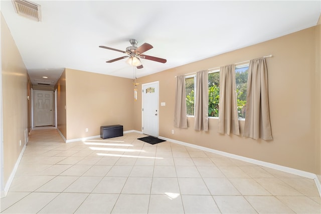 tiled empty room with ceiling fan