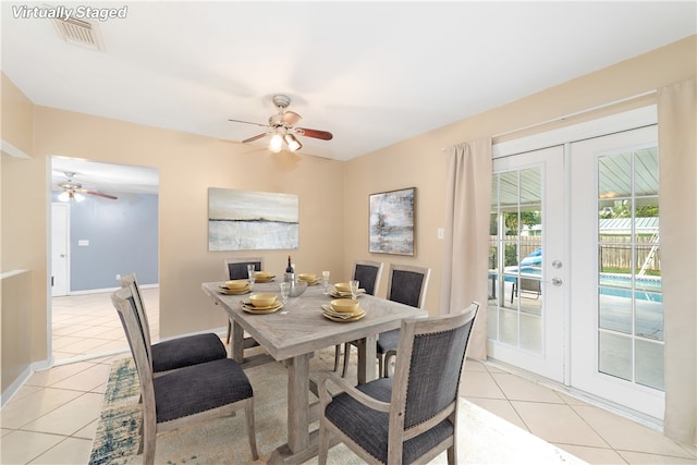 dining room with french doors, light tile patterned floors, and ceiling fan