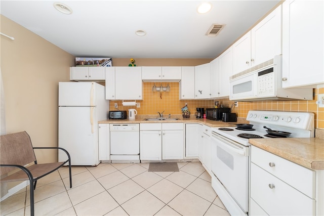 kitchen with white cabinetry, light tile patterned floors, sink, decorative backsplash, and white appliances