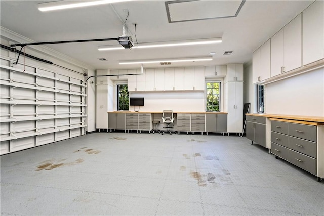 garage with a garage door opener and visible vents