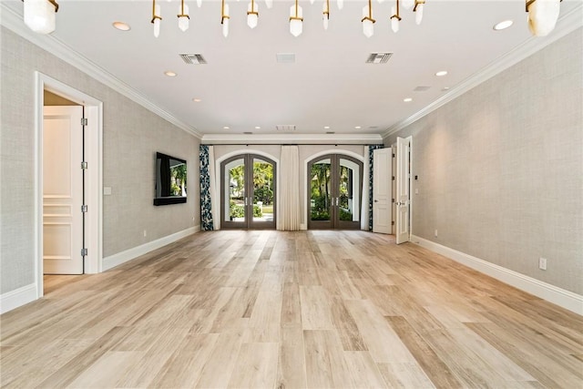 unfurnished living room with light wood-style floors, french doors, and visible vents