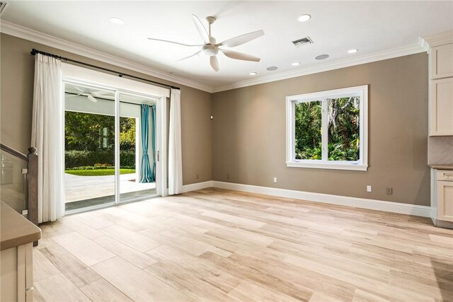 unfurnished living room with visible vents, a ceiling fan, and crown molding