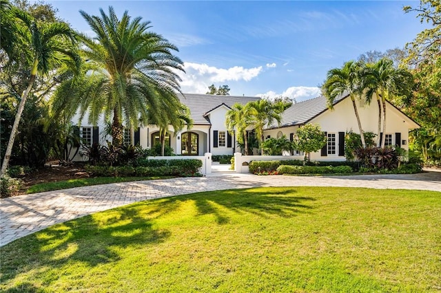 view of front of property featuring a front lawn, a fenced front yard, and stucco siding