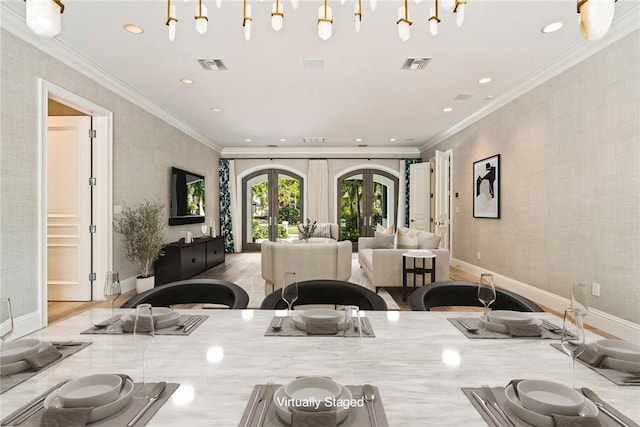 kitchen featuring wood finished floors, french doors, visible vents, and baseboards