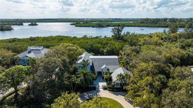 birds eye view of property with a water view and a wooded view