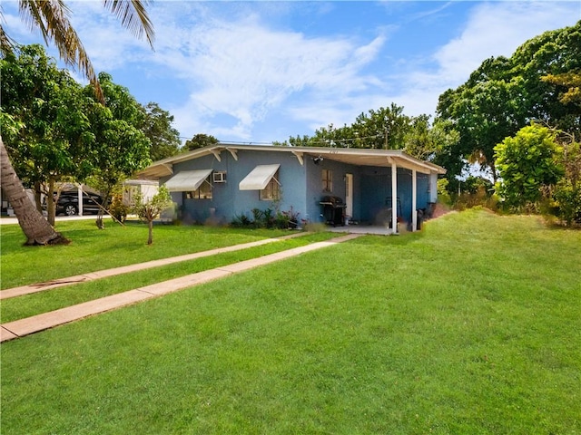 view of front of property with a carport and a front yard