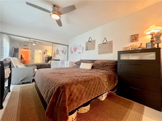 carpeted bedroom with ceiling fan and a closet