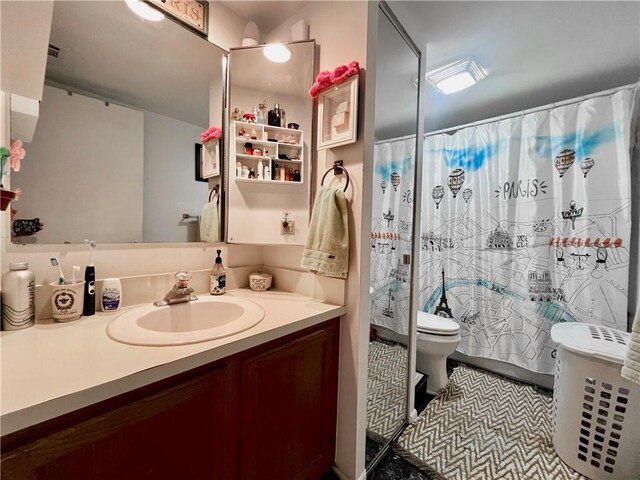 bathroom with tile patterned flooring, toilet, vanity, and a shower with shower curtain