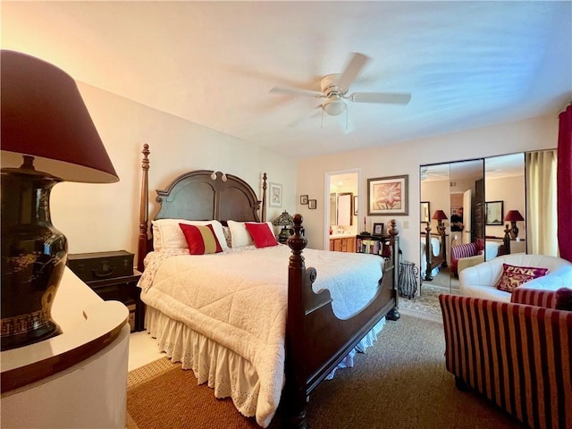 bedroom with ceiling fan, ensuite bathroom, and carpet floors