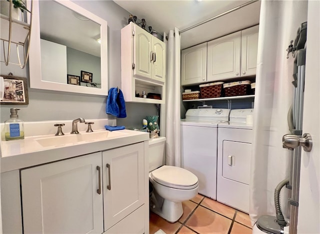 bathroom with vanity, toilet, tile patterned floors, and separate washer and dryer