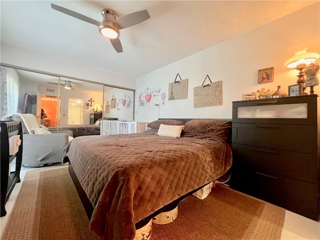 bedroom with a closet, ceiling fan, and carpet floors