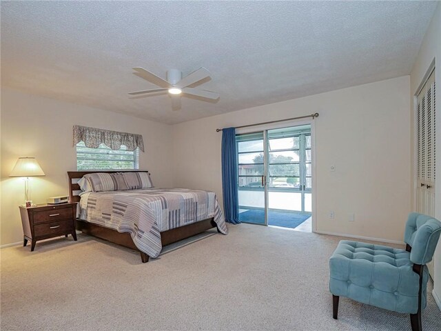 85 Crooked Tree Ln Unit 203, Vero Beach, FL 32962 - bedroom with carpet floors, a textured ceiling, multiple windows, and baseboards
