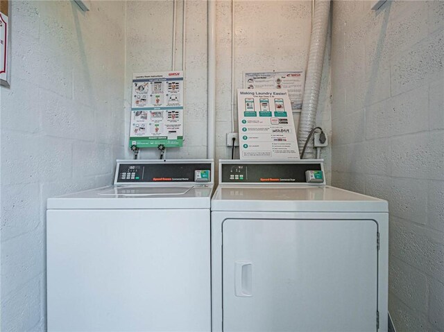 85 Crooked Tree Ln Unit 203, Vero Beach, FL 32962 - community laundry room with concrete block wall and washing machine and clothes dryer