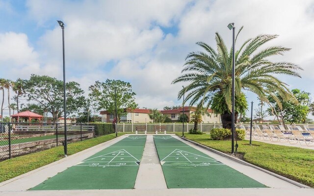 85 Crooked Tree Ln Unit 203, Vero Beach, FL 32962 - surrounding community featuring shuffleboard, a lawn, a gazebo, and fence