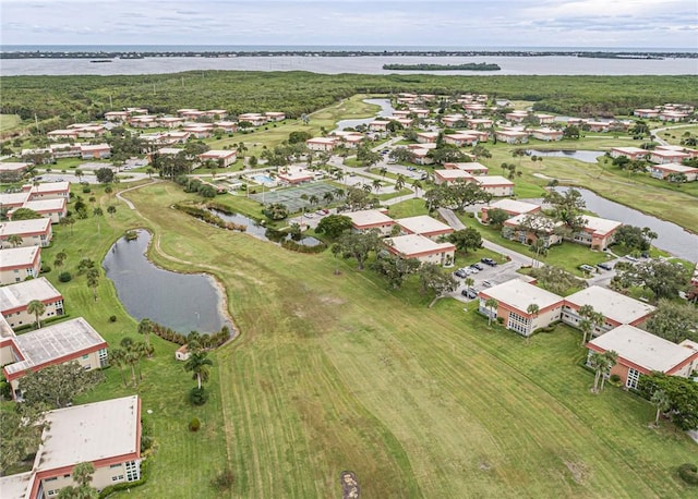 aerial view with a water view, view of golf course, and a residential view