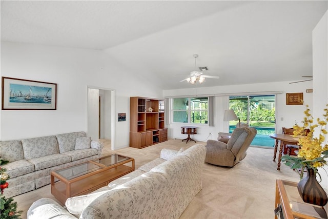 living room featuring ceiling fan, light colored carpet, and vaulted ceiling