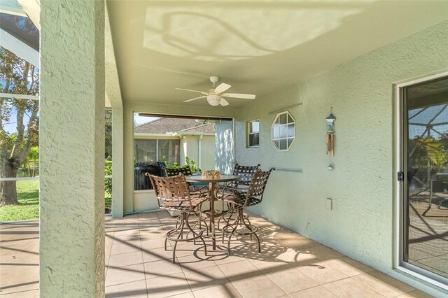 living area featuring light tile patterned floors and ceiling fan