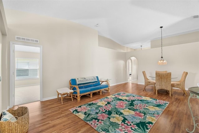 living area featuring hardwood / wood-style floors and lofted ceiling