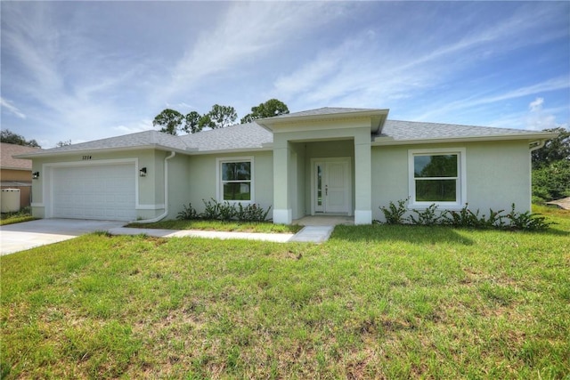 view of front of property with a front yard and a garage