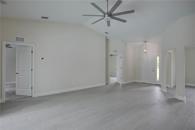 unfurnished living room with high vaulted ceiling, light hardwood / wood-style flooring, and ceiling fan