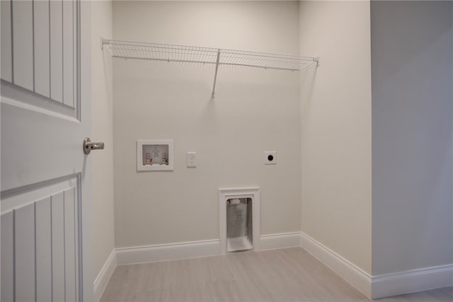 clothes washing area featuring washer hookup and hookup for an electric dryer