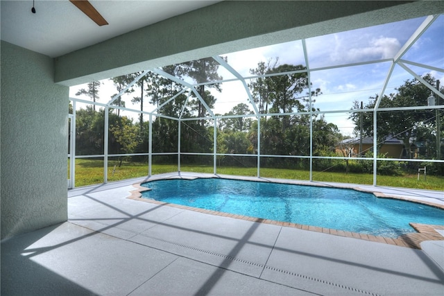 view of swimming pool with a patio and a lanai