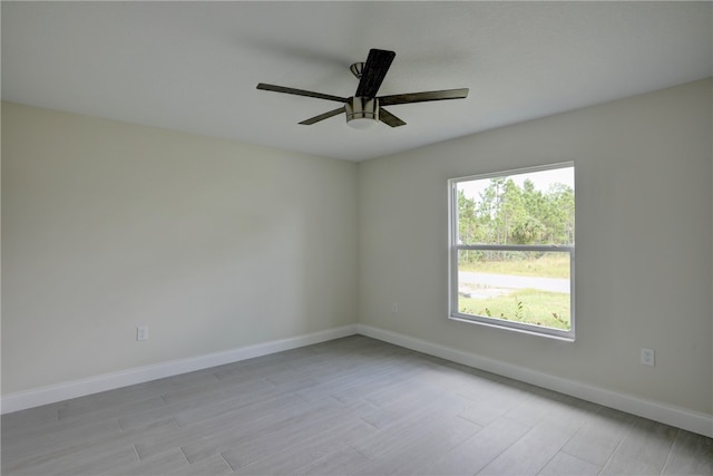 unfurnished room with ceiling fan and light wood-type flooring